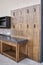 Barbecue grids hang on wainscoting in summer kitchen