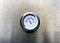 Barbecue grill temperature gauge on stainless steel