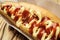 Barbecue Grilled Hot Dog with sauce,Hot Dog With Yellow Mustard,Onion,Pickles and French Fries,Tasty hot-dogs with vegetables on