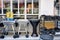 Barbecue grills, charcoals and a disinfection backpack sprayer are displayed at the exterior of a rural store