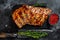 Barbecue pork rack spare ribs on a marble board. Black background. Top view