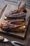 Barbecue pork spare ribs, on wooden serving board, with barbeque knife and meat fork, on old dark  wooden table background