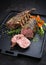 Barbecue rack of lamb with carrot and herbs on a modern design cast iron tray