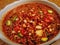 Barbecue Sauce with Sliced Chilies and Garlic in a Small Bowl