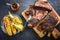 Barbecue sliced chuck beef ribs with hot rub with pineapple and corn on a wooden cutting board