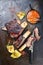 Barbecue smoked sliced hot marinade chuck beef ribs with pineapple and spicy chili sauce sliced on a rustic board