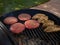 Barbecue in summer with seasoned hamburgers and chicken grilling on a hot grill