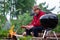 Barbecue time. European man in hat waiting for grilled food.