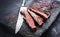 Barbecue wagyu bavette beef steak with red wine salt on charred wooden black board