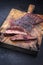 Barbecue wagyu bavette beef steak with red wine salt on an old rustic wooden board