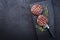 Barbecue Wagyu Hamburger with red wine salt and herbs on a charred wooden board