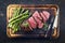 Barbecue Wagyu Sirloin Steak with green Asparagus offered on burnt cutting board