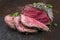 Barbecue Wagyu Sirloin Steak sliced and on an old rustic black board