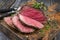 Barbecue Wagyu Sirloin Steak sliced and on a rustic wooden cutting board