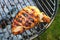 Barbecued marinated chicken breast cooked on charcoal braai