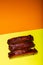 Barbecued and marinated sticky spare rib on yellow and orange background with copy space.