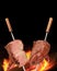 Barbecued Picanha barbecue with blurred fire in the background. Brazilian churrasco or churrasquinho