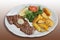 Barbecued rump steak with herb butter,fried potatoes