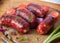 Barbecued sausage on wooden background.