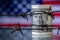 Barbed wire against US Dollar bancnotes as symbol of economic warfare, sanctions and embargo busting