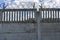 Barbed wire on a concrete fence against a blue sky. Protected area