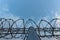 Barbed wire fence with bright blue sky to feel silent and lonely and want freedom. Dramatic clouds behind barbed wire fence on a