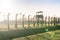 Barbed wire fence with watchtower surrounding extermination camp in Auschwitz Birkenau, Poland