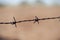 Barbed wire knots wall blurred