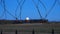 Barbed wire over abstract full moon sky background. Border with barbed wire of prison during night time with moon.