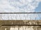 Barbed wire in a prison or in the army. Sharp military security fence. Close-up image. Crossed barbed wire.