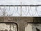 Barbed wire in a prison or in the army. Sharp military security fence. Close-up image. Crossed barbed wire.