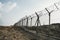 barbed wire steel wall against the immigations. Wall with barbed wire on the border of 2 countries. Private or closed military