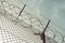 barbed wire steel wall against the immigations. Wall with barbed wire on border of 2 countries. Private or closed military zone