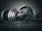 Barbell and dumbell. Sports bodybuilding equipment on black back