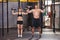 Barbell training man and woman in a gym