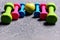 Barbells in different colors and apple placed in pattern, closeup