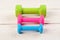 Barbells in green, pink and cyan color placed in pattern,