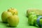 Barbells by juicy green apples. Dumbbells in bright green color