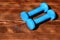 Barbells placed crosswise, top view. Dumbbells made of cyan plastic