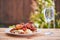 Barbeque chicken drum sticks, spicy and sweet asian style on lettuce salad with bread crumbs.