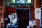 A barber attends a customer at his shop in Jaipur, India