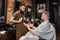 Barber and bearded man in barber shop