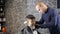 Barber in black gloves gently shaves the child`s nape and whiskey 60 fps