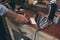 Barber cleaning his workplace with brush, his professional equipment lying