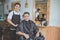 barber with client sitting on a chair ready to get his hair cutted