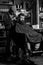 Barber with clipper trimming hair on nape of client. Hipster client getting haircut. Hipster hairstyle concept. Barber