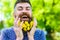 Barber concept. Man with beard and mustache on happy face, green background, defocused. Bearded man with dandelion