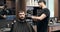 Barber cutting hair with electric trimmer