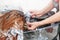 Barber girl washing her hair a client