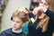 Barber or hair stylist at work. female hairdresser cutting child hair